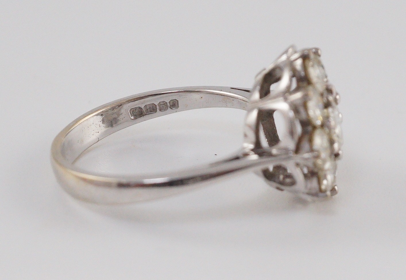 A modern 18ct white gold and nine stone diamond illusion set circular cluster ring